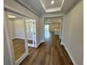 Inviting entryway with stylish wood flooring and views of the open-concept living spaces at 4015 Maggie Loop, Lakeland, FL 33813