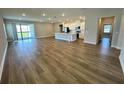 Spacious living room with modern flooring, flowing into the kitchen with a central island at 4015 Maggie Loop, Lakeland, FL 33813