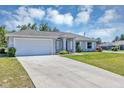 Charming single-story home featuring a two-car garage, well-maintained lawn, and beautiful landscaping at 4126 Sw 132Nd Ln, Ocala, FL 34473