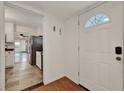 Entryway with tiled floors that flow into the kitchen, and hardwood floors in other rooms at 508 10Th St, St Cloud, FL 34769