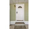 Close-up of the white front door with glass and modern electronic lock at 508 10Th St, St Cloud, FL 34769