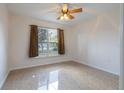 Bright bedroom with tiled flooring, ceiling fan, and natural light from the exterior window at 50989 Highway 27 # 371, Davenport, FL 33897