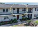 Well-maintained condo with balconies and neatly trimmed bushes around the front entrances at 5505 Hernandes Dr # 204, Orlando, FL 32808