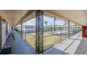 Exterior view from a covered walkway towards the community pool and common areas at 5505 Hernandes Dr # 204, Orlando, FL 32808