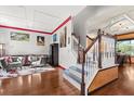 Bright entryway featuring hardwood floors, staircase, and stylish decor at 618 Crownclover Ave, Orlando, FL 32828