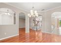 Spacious living room featuring hardwood floors, decorative ceiling, and open floor plan at 618 Crownclover Ave, Orlando, FL 32828
