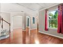 Open-concept living room features hardwood floors, archways, large window, and decorative ceiling at 618 Crownclover Ave, Orlando, FL 32828