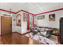Cozy living room with hardwood floors, accent wall, and comfortable seating at 618 Crownclover Ave, Orlando, FL 32828