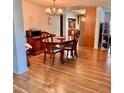 Inviting dining area with hardwood floors, a chandelier, and a round table, creating an ideal space for meals at 76 Oakdale St, Windermere, FL 34786