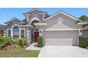 Beautiful home featuring manicured landscaping and an architectural design with a front entry garage at 9915 Kona Isle Ct, Orlando, FL 32817