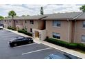Exterior view of a two-story condo with beige stucco siding and parking at 1156 Calle Del Norte # C, Casselberry, FL 32707