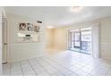 Bright living room with tile flooring and sliding doors to a balcony at 1156 Calle Del Norte # C, Casselberry, FL 32707