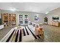 Bright living room boasts natural light, complemented by a stylish striped rug and custom built-in shelving at 12610 Bay Hill Dr, Grand Island, FL 32735