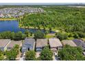 Spacious community with a scenic lake, lush greenery, and well-maintained homes at 12822 Moss Park Ridge Dr, Orlando, FL 32832