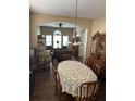Formal dining room with vintage-style furniture and direct access to the adjacent living room at 12822 Moss Park Ridge Dr, Orlando, FL 32832