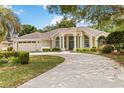 Charming single-story home boasting a curved driveway, a two-car garage, and verdant landscaping at 1320 Antrim Cir, Ormond Beach, FL 32174