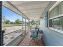 Inviting screened porch with tiled floor, table, chairs, and view of the neighborhood at 1328 Laurel Dr, Daytona Beach, FL 32117