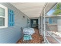 Cozy screened porch with tile flooring, table and chairs, and access to the front entrance at 1328 Laurel Dr, Daytona Beach, FL 32117