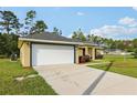 Attractive single-story home with a two-car garage, manicured lawn, and neat landscaping at 13489 Sw 60Th Avenue Rd, Ocala, FL 34473