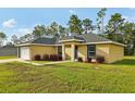 Attractive single-story home with a well-kept lawn and neat landscaping at 13489 Sw 60Th Avenue Rd, Ocala, FL 34473