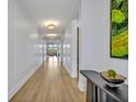 Bright hallway featuring wood flooring, paneled walls, designer lighting, and decor accents at 14559 Walcott Ave, Orlando, FL 32827