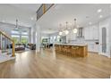 Open-concept kitchen with island, stainless steel appliances, and seamless flow to dining and living areas at 14559 Walcott Ave, Orlando, FL 32827
