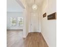 Bright entryway featuring wood-look tile, a decorative chandelier, and an open view into the living room at 1539 Wynell St, St Cloud, FL 34771