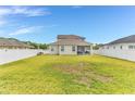 Spacious backyard with lush green grass and a white privacy fence at 16078 St Clair St, Clermont, FL 34714
