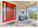 Inviting front porch featuring a decorative rug and two chairs for relaxing at 16078 St Clair St, Clermont, FL 34714