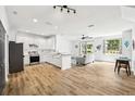 Open-concept kitchen featuring modern appliances, white cabinetry, and stylish tile backsplash at 1986 Yellowfin Dr, Port Orange, FL 32128