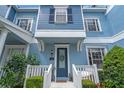 Charming blue two-story home with white trim and well-manicured landscaping at 316 Solaris Wharf St, Winter Springs, FL 32708