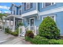 Lovely blue townhome with manicured front yard and inviting entrance, perfect for relaxing at 316 Solaris Wharf St, Winter Springs, FL 32708
