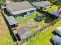 Fenced backyard with lawn, patio, storage shed, and a trampoline at 3328 Fox Ridge, Winter Haven, FL 33884