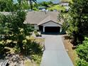 Aerial view of a single-story home with a long driveway leading to an attached two-car garage at 3328 Fox Ridge, Winter Haven, FL 33884