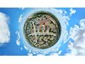 Unique 360 aerial view of the home nestled in a peaceful neighborhood with lush green surroundings and clear blue skies at 337 Giovani Blvd, Clermont, FL 34715