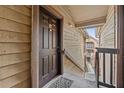 Apartment entrance with a dark wooden door, a welcome mat, and a glimpse of the building's exterior at 390 Lake Placid Ct # 304, Altamonte Springs, FL 32701