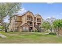 Charming multi-story apartment with balconies, well-kept lawn, and inviting walkways at 390 Lake Placid Ct # 304, Altamonte Springs, FL 32701