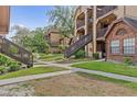 Exterior view of the condo building with well-maintained landscaping and walkways at 390 Lake Placid Ct # 304, Altamonte Springs, FL 32701