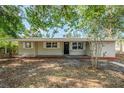 Charming single-story home with a dark front door and well-manicured landscaping in the front yard at 4124 Caywood Cir, Orlando, FL 32810