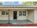 Welcoming front porch featuring a dark front door with sidelights and a covered entryway at 4124 Caywood Cir, Orlando, FL 32810