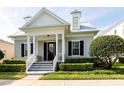 Inviting home exterior featuring a covered porch, dormer windows, neat landscaping, and a welcoming entrance at 4148 Oak St, Orlando, FL 32814