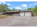 Charming home features a covered porch and a two-car garage with long driveway at 424 Eden Park Rd, Altamonte Springs, FL 32714