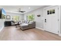 Inviting living room with hardwood floors, a comfortable sectional sofa, and plenty of natural light at 51 Spruce Ln, Debary, FL 32713