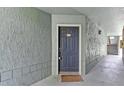 A welcoming entrance featuring a classic dark-colored door with a cozy welcome mat at 5112 Conroy Rd # 13, Orlando, FL 32811