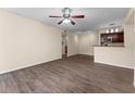 Spacious living room with sleek flooring and a view of the modern kitchen area at 5112 Conroy Rd # 13, Orlando, FL 32811
