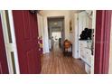 Welcoming foyer with hardwood floors and stylish decor leading into the home at 7415 Devereaux St, Reunion, FL 34747