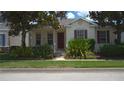 Inviting single-story home featuring a well-manicured lawn and mature trees at 7415 Devereaux St, Reunion, FL 34747