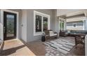 Inviting covered front porch featuring comfortable seating, a stylish rug, and a decorative pillow at 9405 Bordet Ct, Orlando, FL 32827