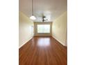 Bright living room features wood-look floors, fresh paint, a ceiling fan, and an abundance of natural light at 1224 S Hiawassee Rd # 638, Orlando, FL 32835
