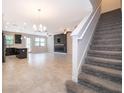 Bright living room with staircase, tile flooring, and modern fireplace at 1227 Sandwedge St, Davenport, FL 33896